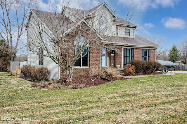 view of front facade featuring a shingled roof, a front yard, and brick siding