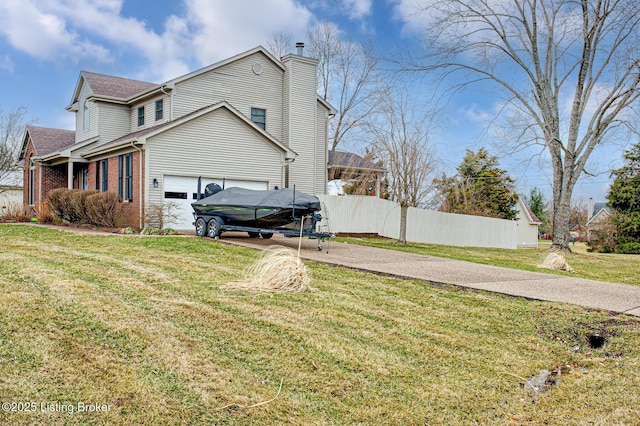 view of side of home featuring a garage, brick siding, fence, concrete driveway, and a yard