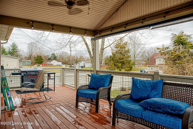 deck featuring ceiling fan, a residential view, and area for grilling