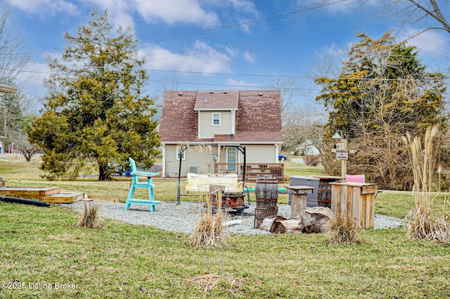 exterior space featuring roof with shingles and a yard