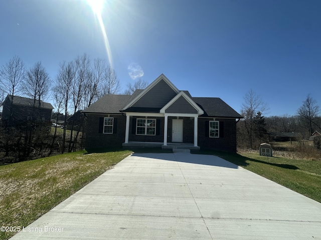 craftsman-style home with covered porch and a front lawn