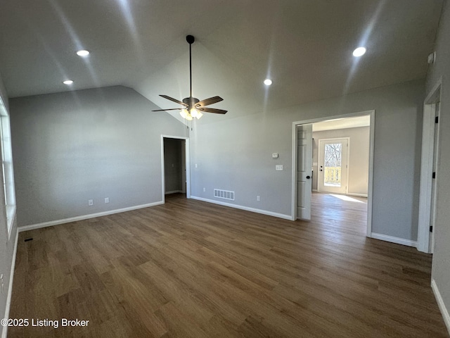 unfurnished room with visible vents, a ceiling fan, wood finished floors, baseboards, and lofted ceiling