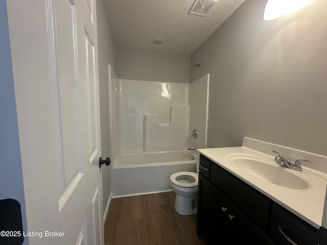 bathroom with vanity, wood finished floors, visible vents, toilet, and shower / bathtub combination