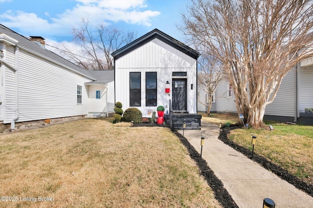 view of front of home featuring a front lawn and board and batten siding