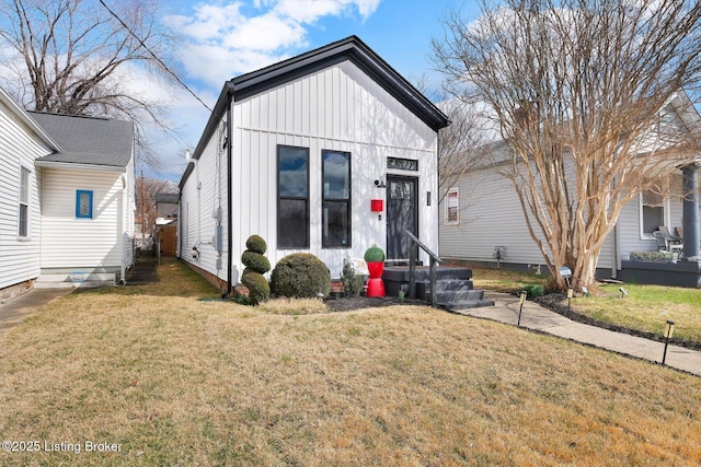 view of front of property with a front lawn and board and batten siding