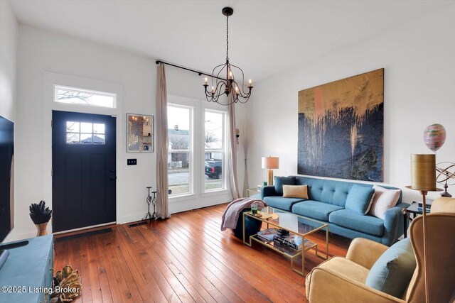 living area featuring wood-type flooring and a notable chandelier