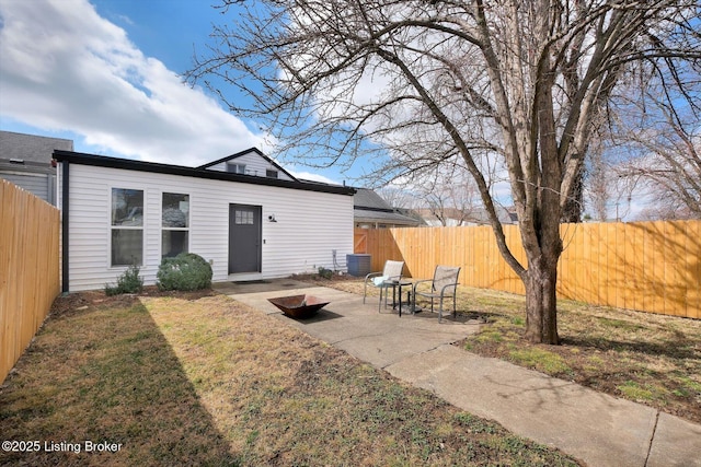 back of property featuring a yard, a patio area, a fenced backyard, and central air condition unit