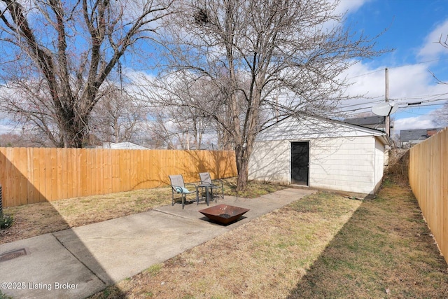 view of yard with a fenced backyard, an outdoor structure, and a patio