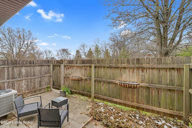 view of patio / terrace with central AC and a fenced backyard