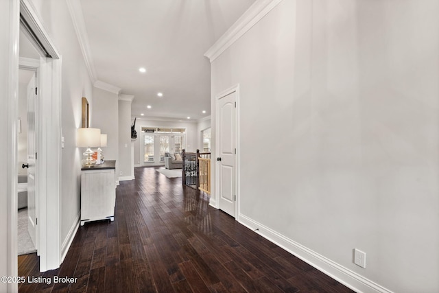 corridor with baseboards, dark wood-style flooring, crown molding, and recessed lighting