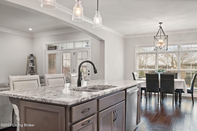 kitchen featuring dishwasher, a sink, dark wood-style floors, and crown molding