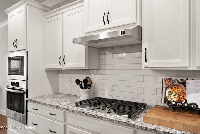 kitchen with white cabinetry, stainless steel gas stovetop, and under cabinet range hood