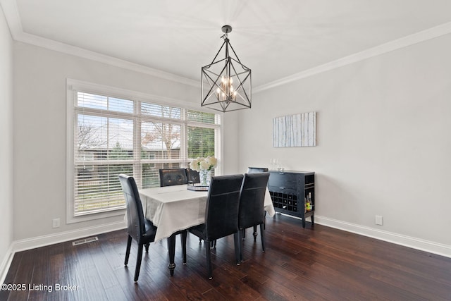 dining area with ornamental molding, dark wood-style flooring, visible vents, and baseboards