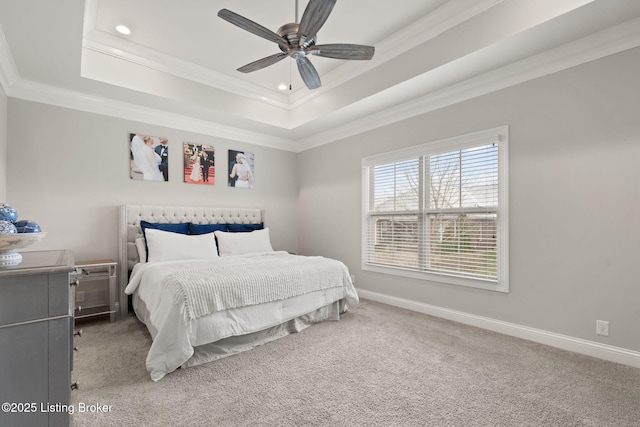 bedroom featuring baseboards, a tray ceiling, carpet flooring, and ornamental molding