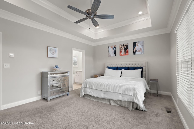 bedroom featuring multiple windows, a raised ceiling, and crown molding