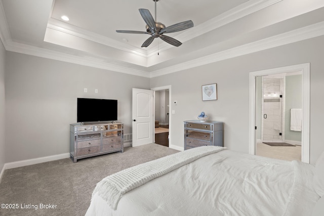 bedroom with ornamental molding, a tray ceiling, and carpet floors