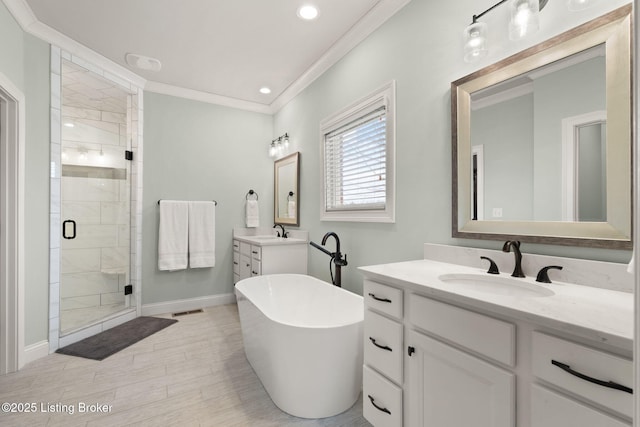 full bathroom featuring crown molding, a soaking tub, a sink, and a shower stall