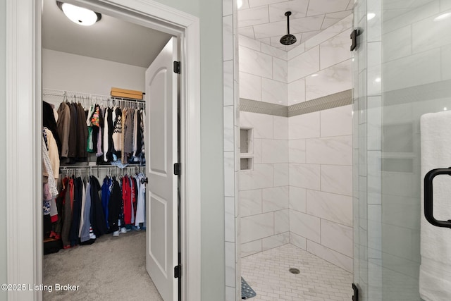 full bath featuring a spacious closet and a stall shower