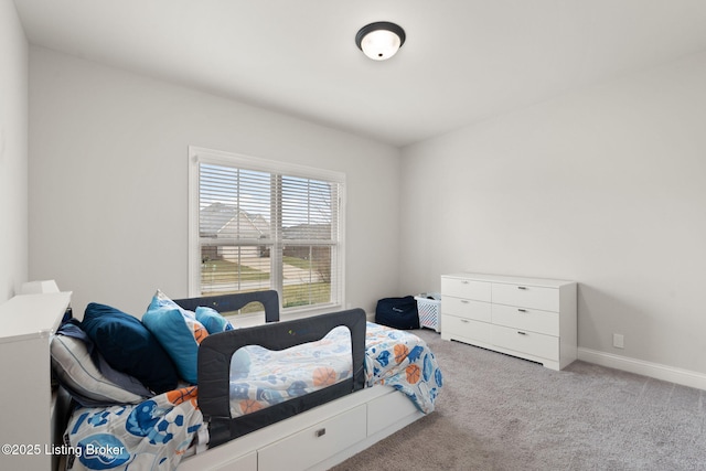 bedroom featuring carpet and baseboards