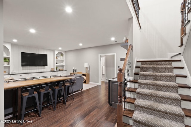 interior space featuring recessed lighting, baseboards, and wood finished floors