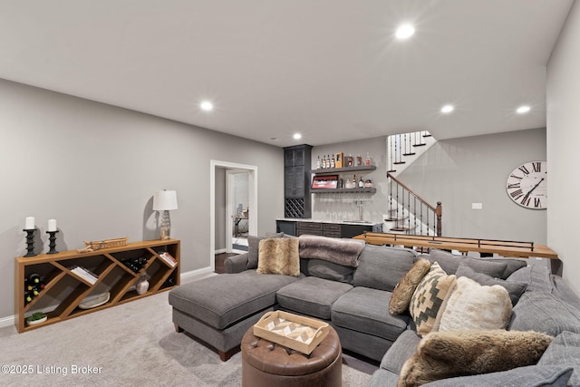 carpeted living room featuring recessed lighting, baseboards, stairway, and a dry bar