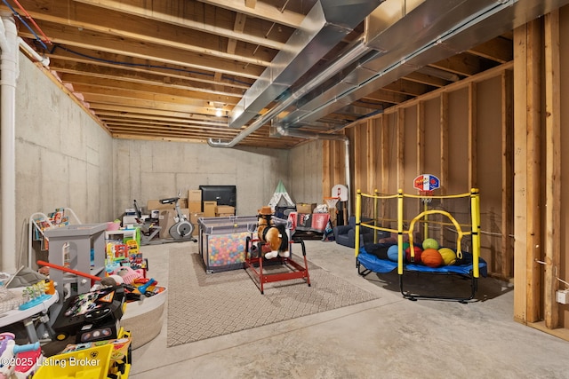 recreation room featuring unfinished concrete floors