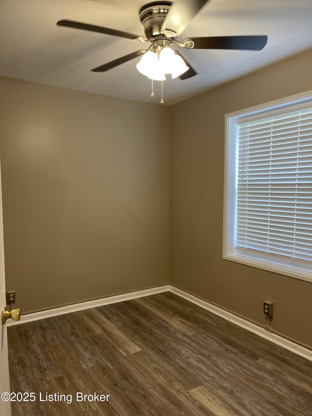 spare room featuring dark wood-style floors, baseboards, and ceiling fan