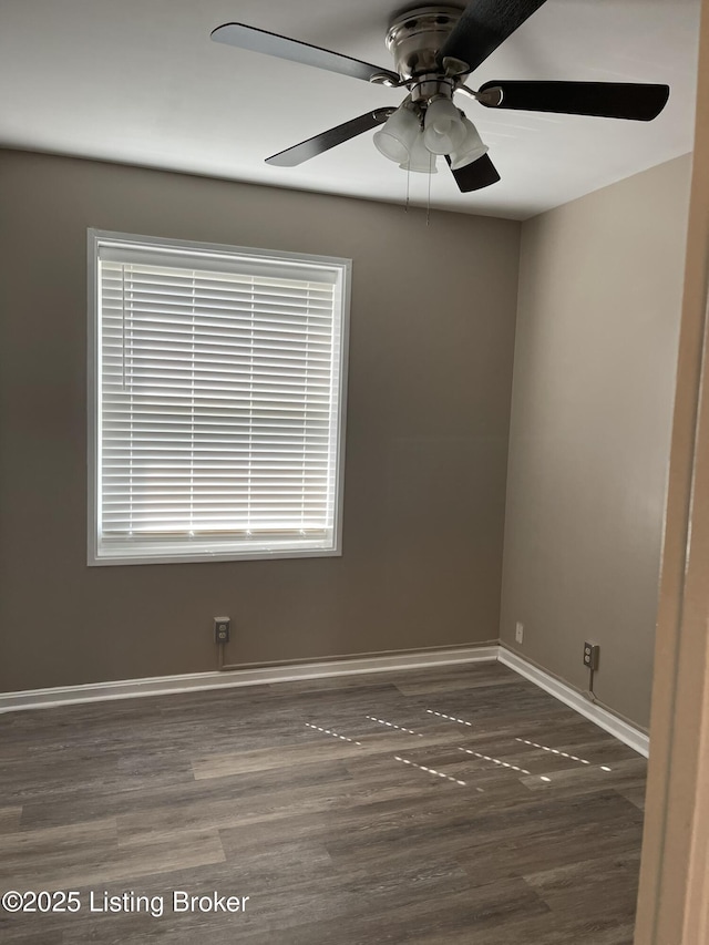 spare room with a healthy amount of sunlight, a ceiling fan, baseboards, and wood finished floors