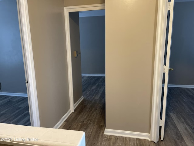 hall with wood finished floors and baseboards