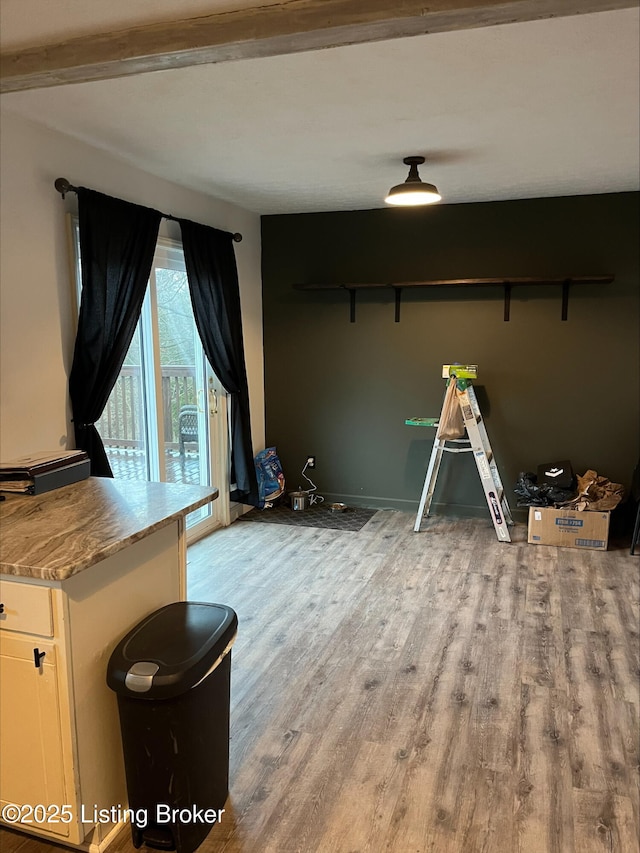 interior space with baseboards and light wood finished floors