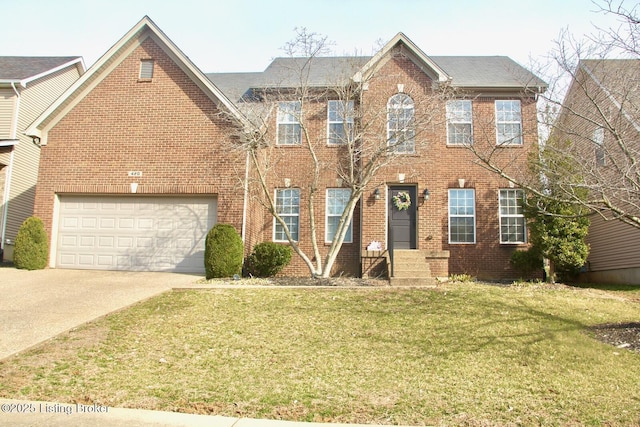 colonial-style house with a front yard, concrete driveway, brick siding, and an attached garage