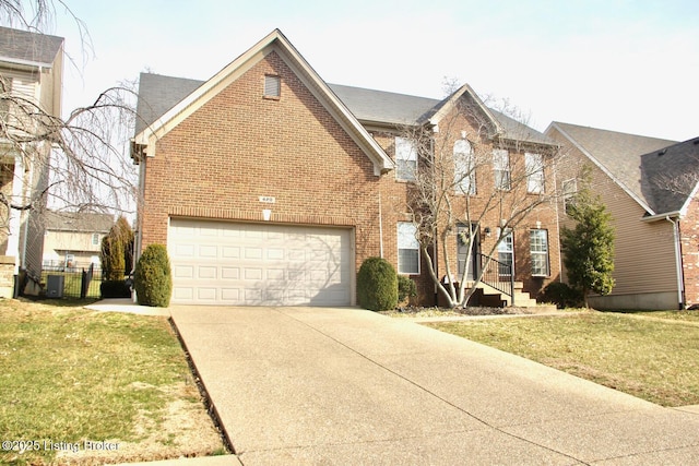 view of front facade with a garage, brick siding, concrete driveway, fence, and a front yard