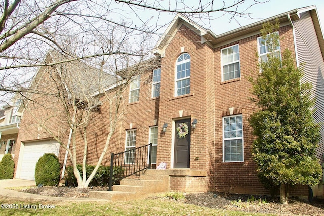 view of front of home featuring concrete driveway, brick siding, and an attached garage