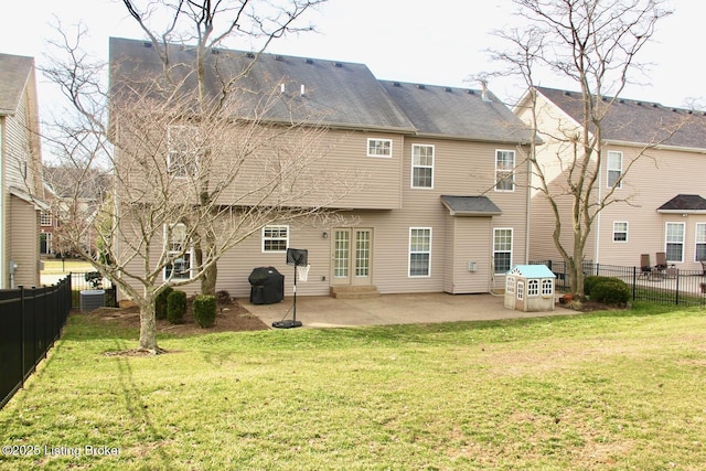 back of house with a fenced backyard, a lawn, and a patio
