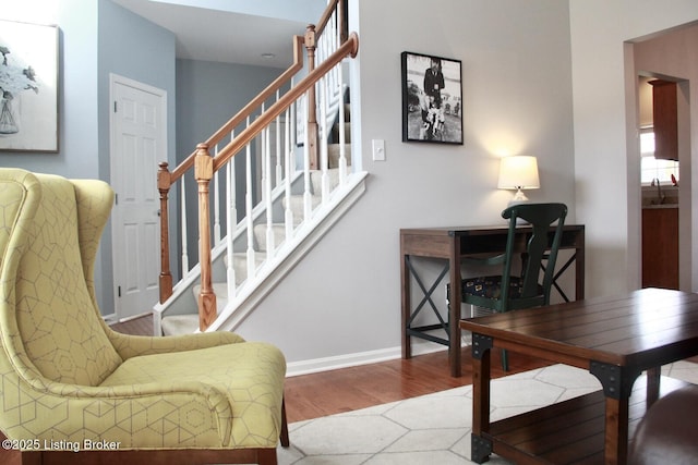 interior space featuring stairs, baseboards, and wood finished floors