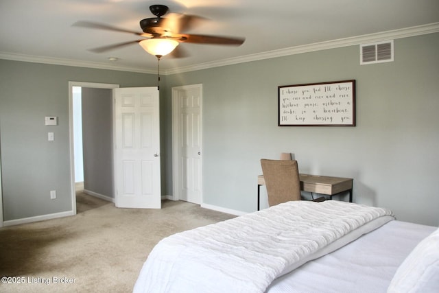 carpeted bedroom featuring a ceiling fan, baseboards, visible vents, and crown molding
