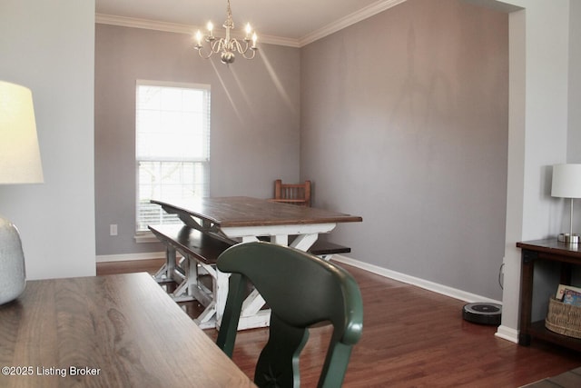 dining room with baseboards, a notable chandelier, ornamental molding, and wood finished floors