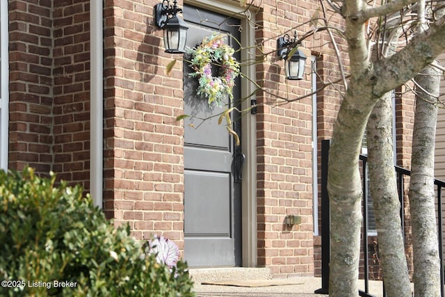 entrance to property featuring brick siding