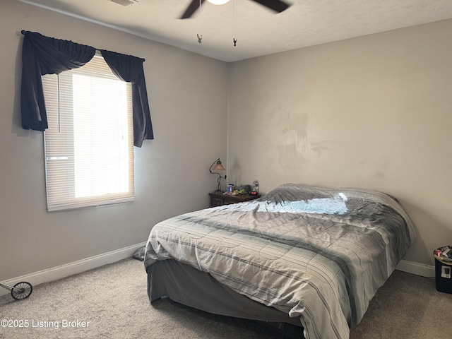 carpeted bedroom featuring ceiling fan and baseboards