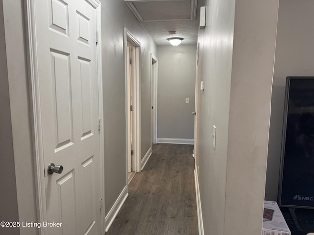 hallway with dark wood-style flooring and baseboards