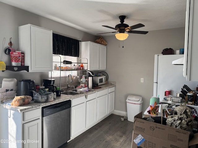 kitchen featuring dark wood-style flooring, light countertops, white cabinets, a sink, and white appliances