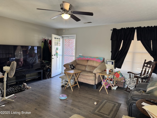 living area featuring ceiling fan, visible vents, and wood finished floors