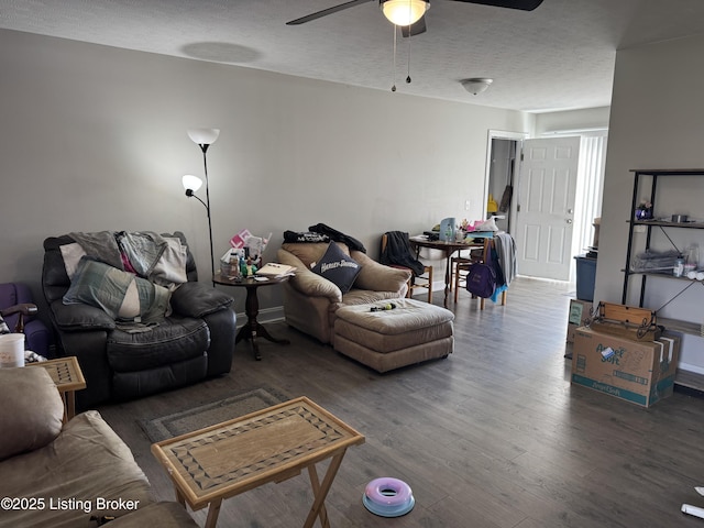 living area with a ceiling fan, a textured ceiling, and wood finished floors