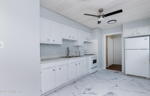 kitchen with white appliances, ceiling fan, a sink, light countertops, and white cabinetry