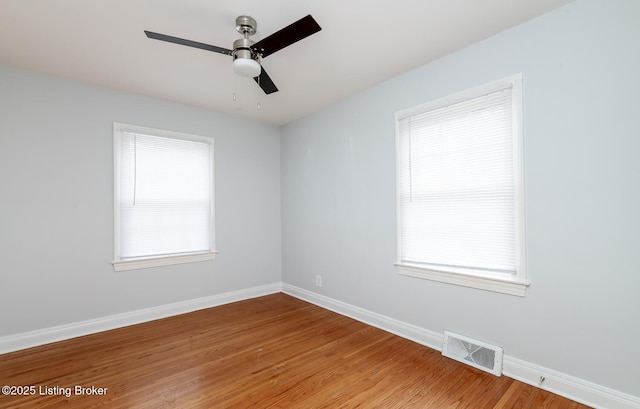 spare room with visible vents, baseboards, light wood-style floors, and a ceiling fan