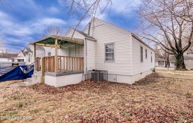 back of house featuring crawl space