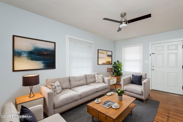 living room featuring a ceiling fan and wood finished floors