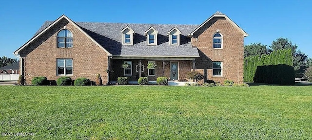 view of front of home featuring a front lawn and brick siding