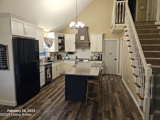 kitchen with dishwashing machine, a sink, custom exhaust hood, freestanding refrigerator, and stainless steel electric range oven