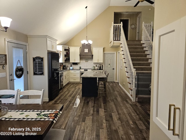 kitchen featuring stainless steel stove, a kitchen breakfast bar, custom exhaust hood, a center island, and dark wood finished floors